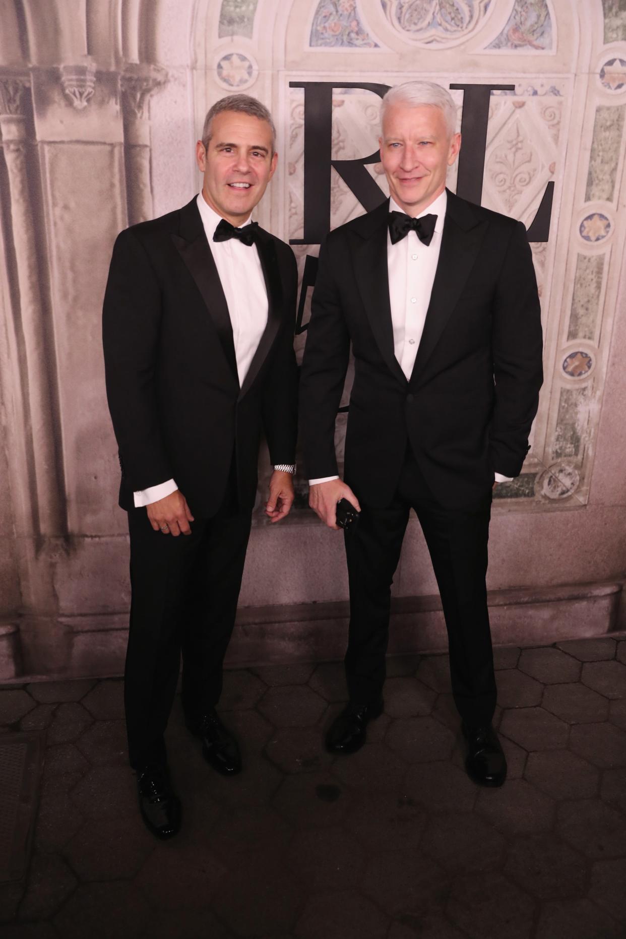 Andy Cohen, left, and Anderson Cooper, seen at a Ralph Lauren fashion show in 2018, shared an awkward, touching and risque moment as they honored Cooper's mother, Gloria Vanderbilt, who died in June, during CNN's New Year's Eve broadcast Tuesday.