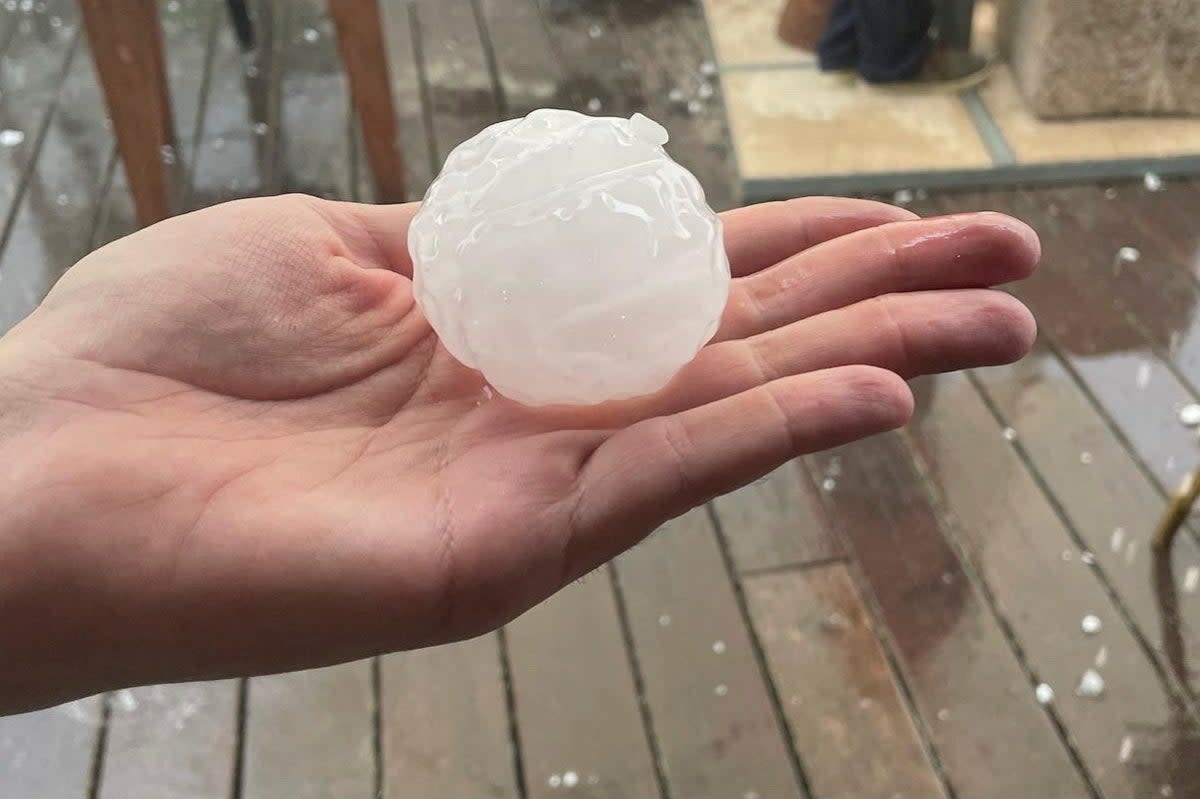 A person holds up a hailstone during a violent hailstorm in Girona, Spain, on August 30  (Sicus Carbonell via REUTERS)