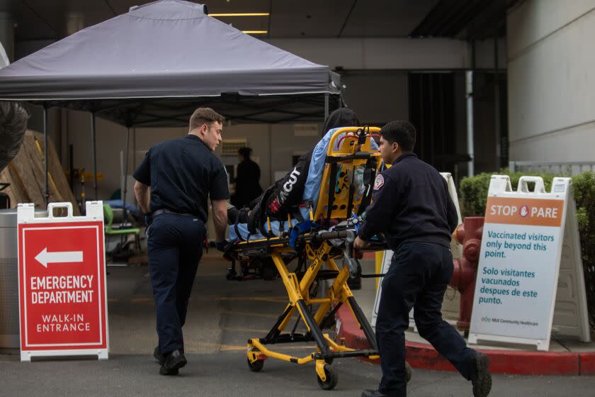 Los Angeles, CA - December 16: Ambulances line up outside the emergency department as they transport patients into MLK Community Hospital on Friday, Dec. 16, 2022, in Los Angeles, CA. (Francine Orr / Los Angeles Times)