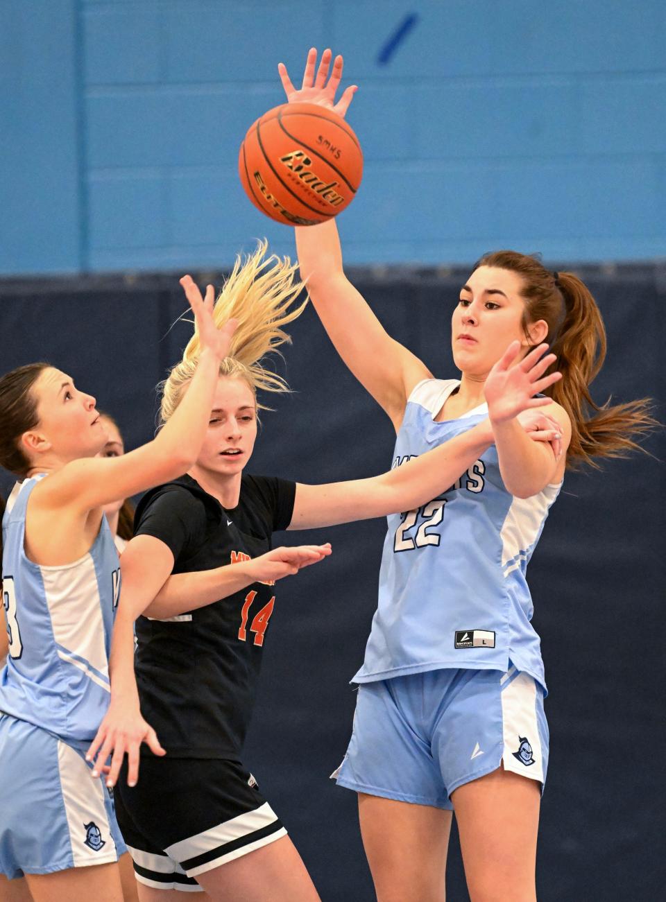 In Tuesday action, Madi Lawrence (22) and Avery Cobban of Sandwich break up a drive by Hailey Iwanski of Middleborough.