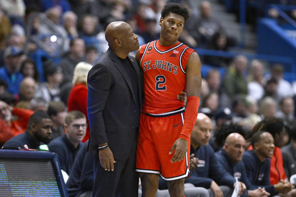 St. John's head coach Mike Anderson talks with St. John's AJ Storr (2) in the first half of an NCAA college basketball game against Connecticut, Sunday, Jan. 15, 2023, in Hartford, Conn. (AP Photo/Jessica Hill)