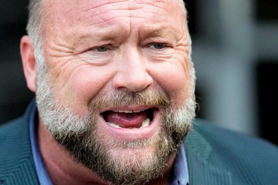 Right-wing conspiracy theorist Alex Jones speaks to the media after arriving at the federal courthouse for a hearing in front of a bankruptcy judge Friday, June 14, 2024 (AP)