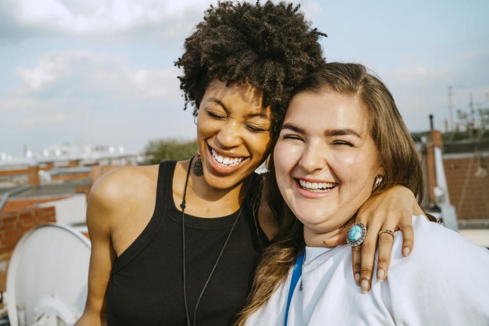 Two women laughing and hugging