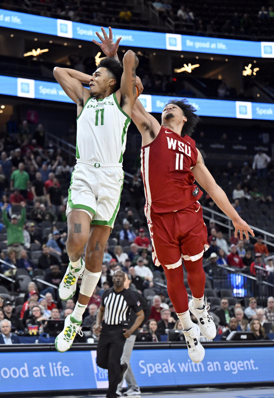 Oregon guard Rivaldo Soares, left, shoots against Washington State forward DJ Rodman during the second half of an NCAA college basketball game in the quarterfinals of the Pac-12 Tournament, Thursday, March 9, 2023, in Las Vegas. (AP Photo/David Becker)