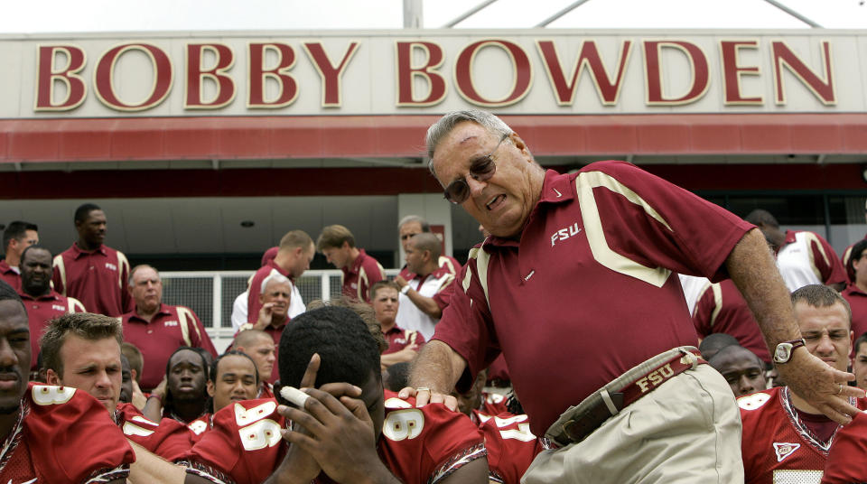FILE - In this Aug. 12, 2007, file photo, Florida State head football coach Bobby Bowden, right, squeezes into his seat for a team photo during media day activities in Tallahassee, Fla. The Hall of Fame college football coach Bobby Bowden has died after a battle with pancreatic cancer. Exuding charm and wit, Bowden led Florida State to two national championships and a record of 315-98-4 during his 34 seasons with the Seminoles. In all, Bowden had 377 wins during his 40 years in major college coaching. He was 91 years old. (AP Photo/Phil Coale, File)