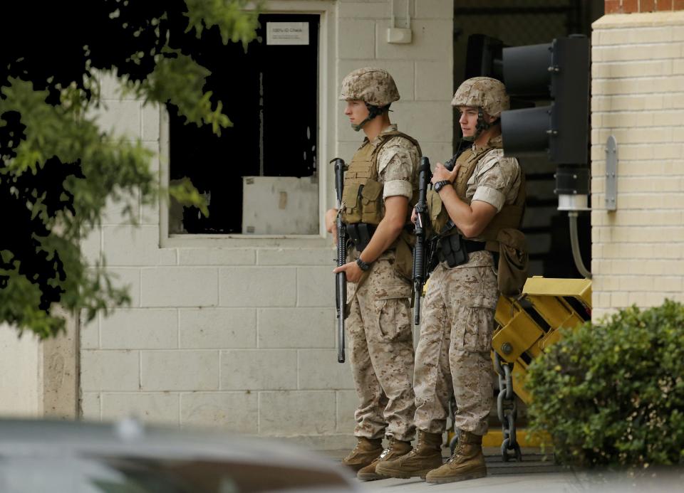 Armed security personnel keep a watchful eye as police respond to reports of a shooting and subsequent lockdown at the U.S. Navy Yard in Washington