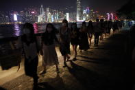 People form a human chain in support of protest movement in the harbor area in Hong Kong, Monday, Sept. 30, 2019. Hong Kong police warned Monday of the potential for protesters in the semi-autonomous Chinese territory to engage in violence "one step closer to terrorism" during this week's National Day events, an assertion ridiculed by activists as propaganda meant to scare people from taking to the streets. (AP Photo/Gemunu Amarasinghe)