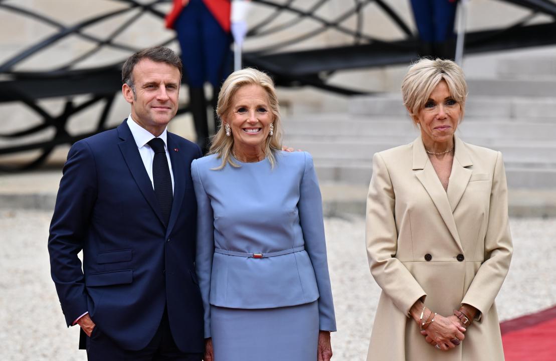 PARIS, FRANCE - JULY 26: France's President Emmanuel Macron (L) and his wife Brigitte Macron (R) greet US First Lady Jill Biden (C) on arrival ahead of a reception for heads of state and governments ahead of the opening ceremony of the Paris 2024 Olympic Games, at the Elysee presidential palace in Paris, on July 26, 2024. (Photo by Mustafa Yalcin/Anadolu via Getty Images)