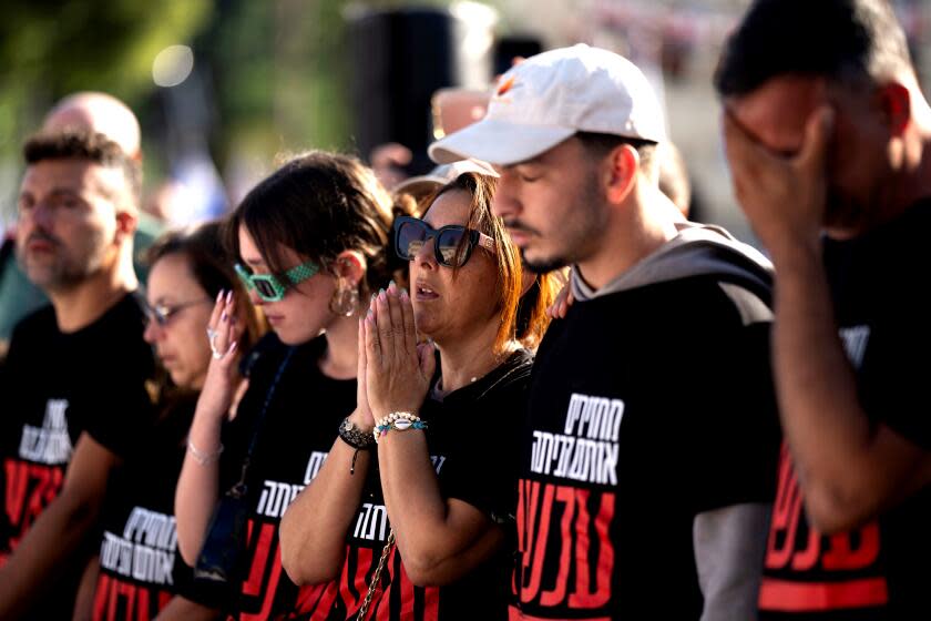 Relatives of people kidnapped by Hamas militants pray in central Tel Aviv on Friday, Oct. 20, 2023