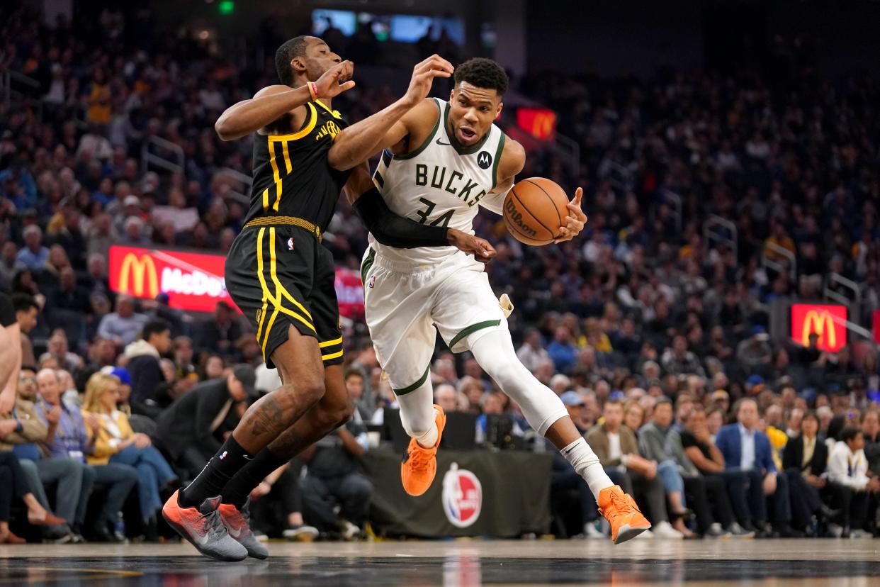 Bucks forward Giannis Antetokounmpo drives past Warriors forward Jonathan Kuminga in the second quarter Wednesday night.