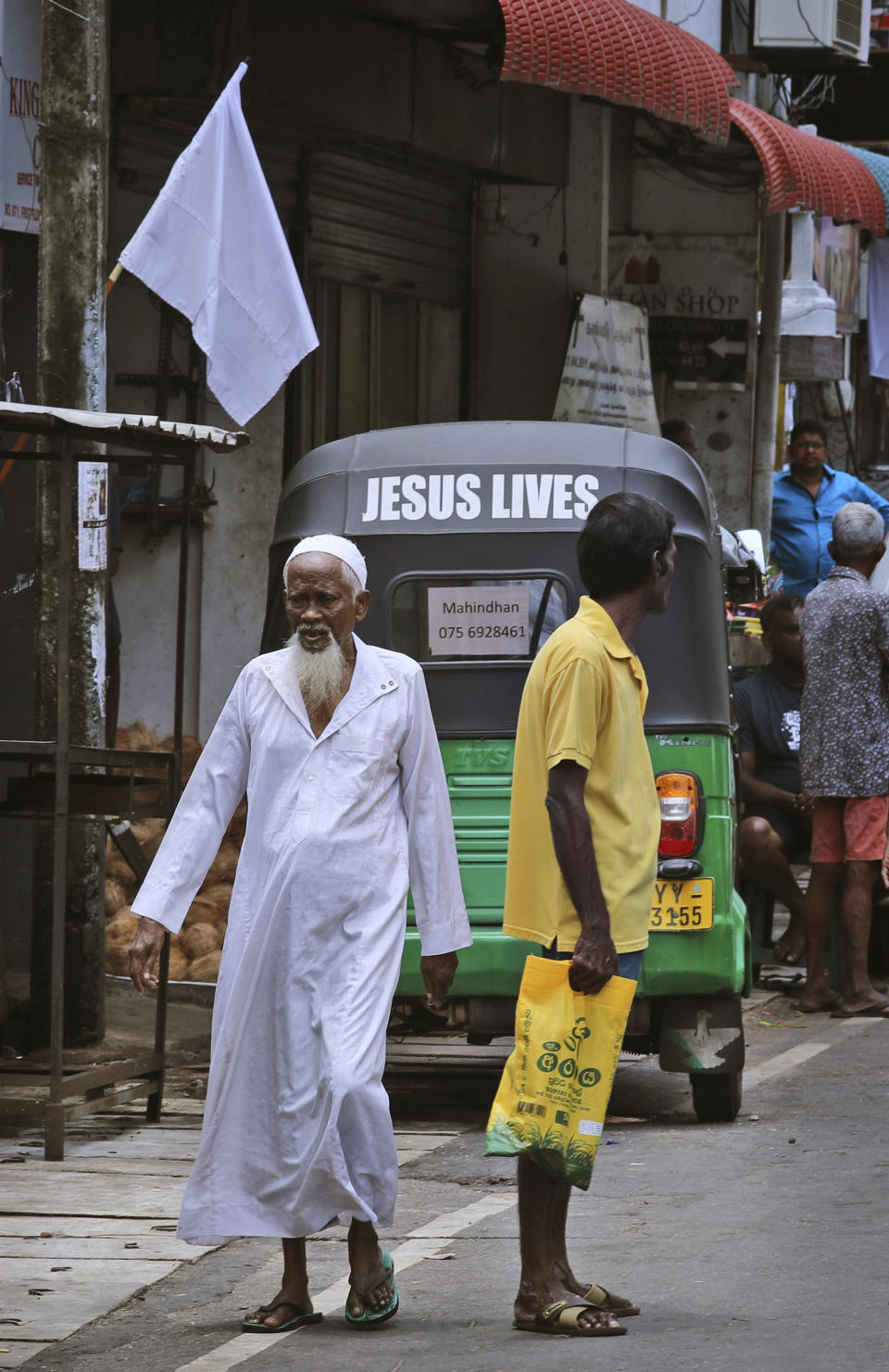 An elderly Sri Lankan Muslim man walks across a street in Colombo, Sri Lanka, Monday, April 29, 2019. The Catholic Church in Sri Lanka said Monday that the government should crack down on Islamic extremists with more vigor "as if on war footing" in the aftermath of the Easter bombings. Meanwhile, the government has banned all kinds of face coverings that may conceal people's identities. The emergency law, which took effect Monday, prevents Muslim women from veiling their faces. (AP Photo/Manish Swarup)
