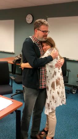 Kevin Garratt, a Canadian held in China for two years on suspicion of spying, hugs his wife Julia Garratt after being deported by Chinese authorities, in Vancouver, British Columbia, Canada, in this handout picture taken and released by the Garratt family September 15, 2016. Courtesy of the Garratt Family/Handout via Reuters