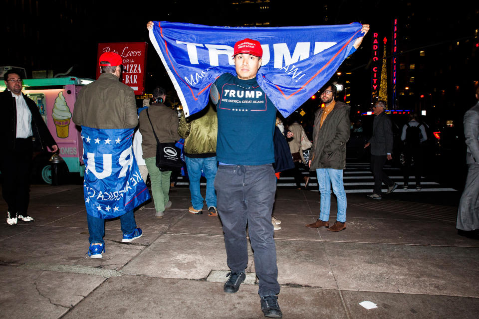 People hold signs in support of Donald Trump, 2016 Republican presidential nominee, while standing outside of Fox News headquarters in New York, on Nov. 8.&nbsp;