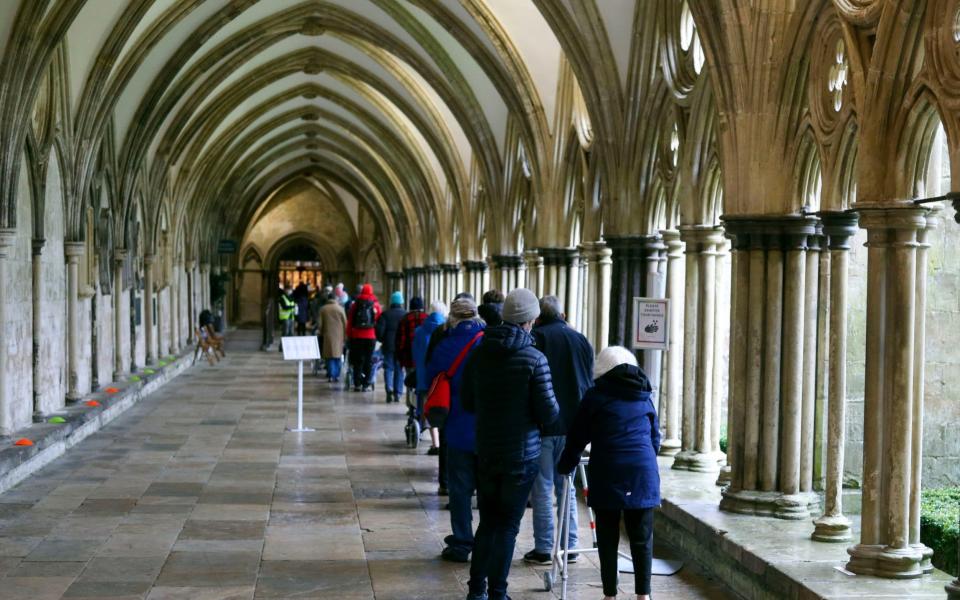 People queue outside Salisbury Cathedral, Wiltshire, to recieve an injection of the Pfizer coronavirus vaccine - PA