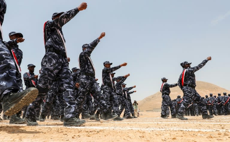 UAE-trained cadets of the Yemeni police march during their graduation in Mukalla on August 8, 2018, during a press trip arranged by the UAE