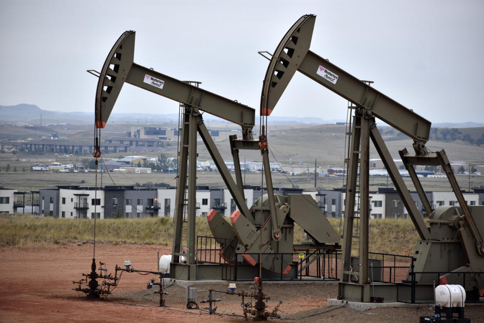 Pump jacks stand with apartments in the background Aug. 26, 2021, on the outskirts of Watford City, N.D., part of McKenzie County, the fastest-growing county in the U.S. That's according to new figures from the Census Bureau. ​(AP Photo/Matthew Brown)