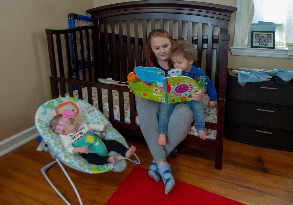 Patricia, center, reads to her son, Noah, 15 months, as her daughter, Annalyce, three months ,looks on, at their home in Bristol Township, on Friday, Nov. 18,. 2022.