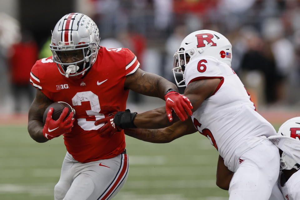 Ohio State running back Miyan Williams, left, runs past Rutgers defensive back Christian Braswell during the second half of an NCAA college football game, Saturday, Oct. 1, 2022, in Columbus, Ohio. (AP Photo/Jay LaPrete)