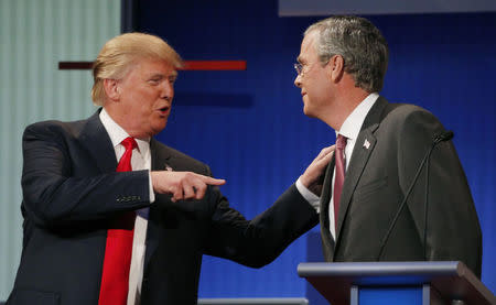 Donald Trump (L) talks with fellow candidate and former Jeb Bush during a commercial break at the first official Republican presidential candidates debate of the 2016 U.S. presidential campaign in Cleveland, Ohio, August 6, 2015. REUTERS/Brian Snyder