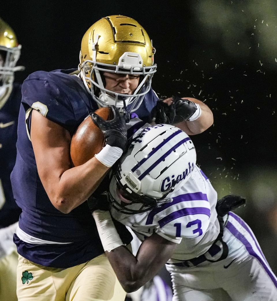 Cathedral Fighting Irish Zach Meeks (3) is pushed out of bounds by Ben Davis Giants Yassine Falke (13) on Friday, Nov. 10, 2023, during the IHSAA Class 6A regional championship game at Key Stadium at University of Indianapolis. The Ben Davis Giants defeated the Cathedral Fighting Irish, 27-24.