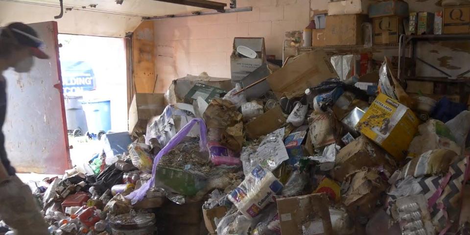 A garage piled high with trash.