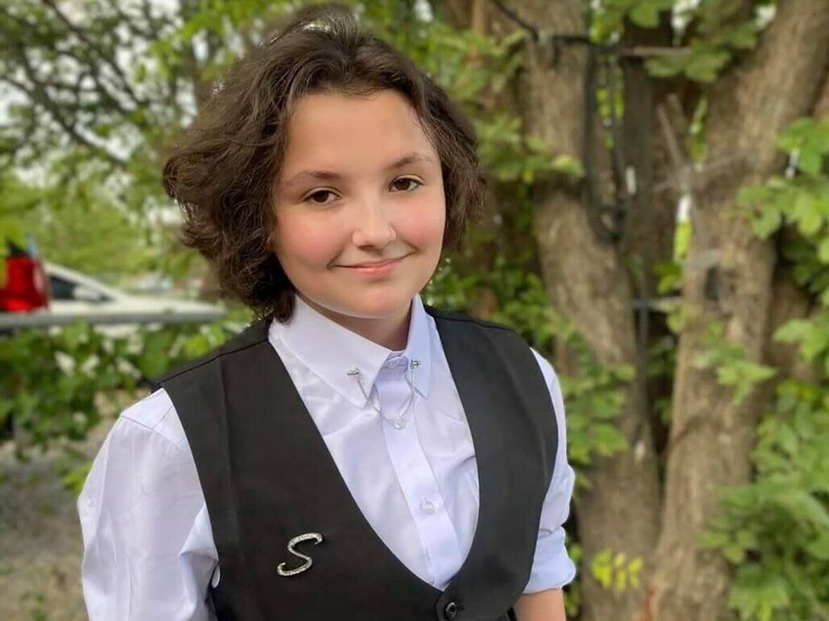 Nex Benedict, pictured outside their family's home in Owasso, Okla., in December 2023, died on Feb. 8, a day after the non-binary 16-year-old told a police officer they had been bullied in a bathroom at school. (Sue Benedict/The Associated Press - image credit)