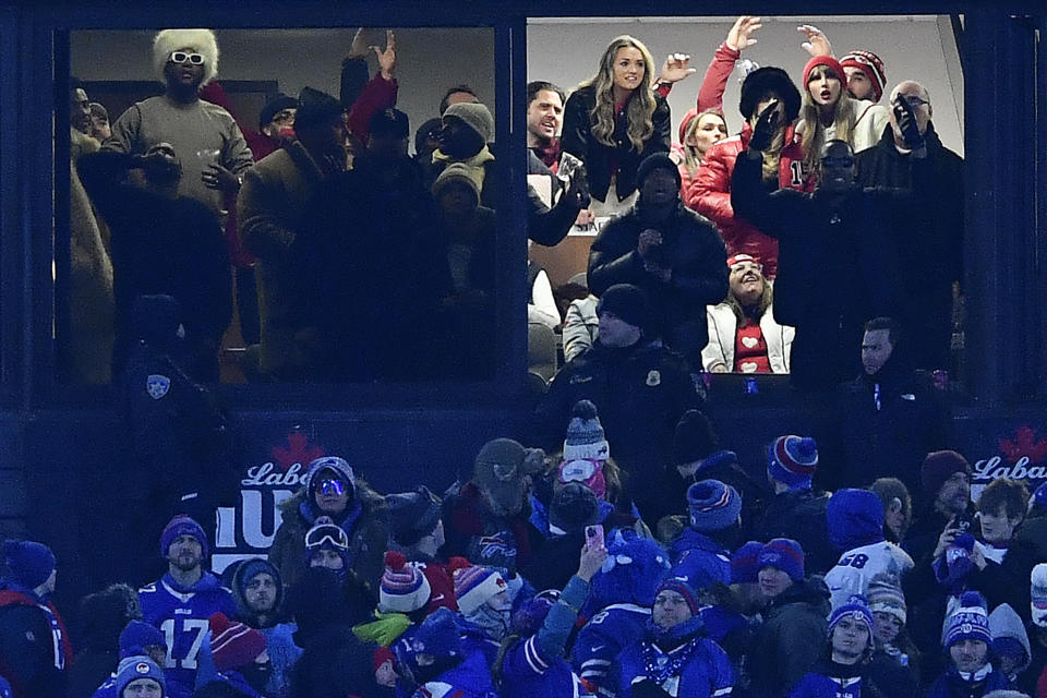 Taylor Swift, right, watches as Kansas City Chiefs tight end Travis Kelce scores a touchdown against the Buffalo Bills during the third quarter of an NFL AFC division playoff football game, Sunday, Jan. 21, 2024, in Orchard Park, N.Y. (AP Photo/Adrian Kraus)