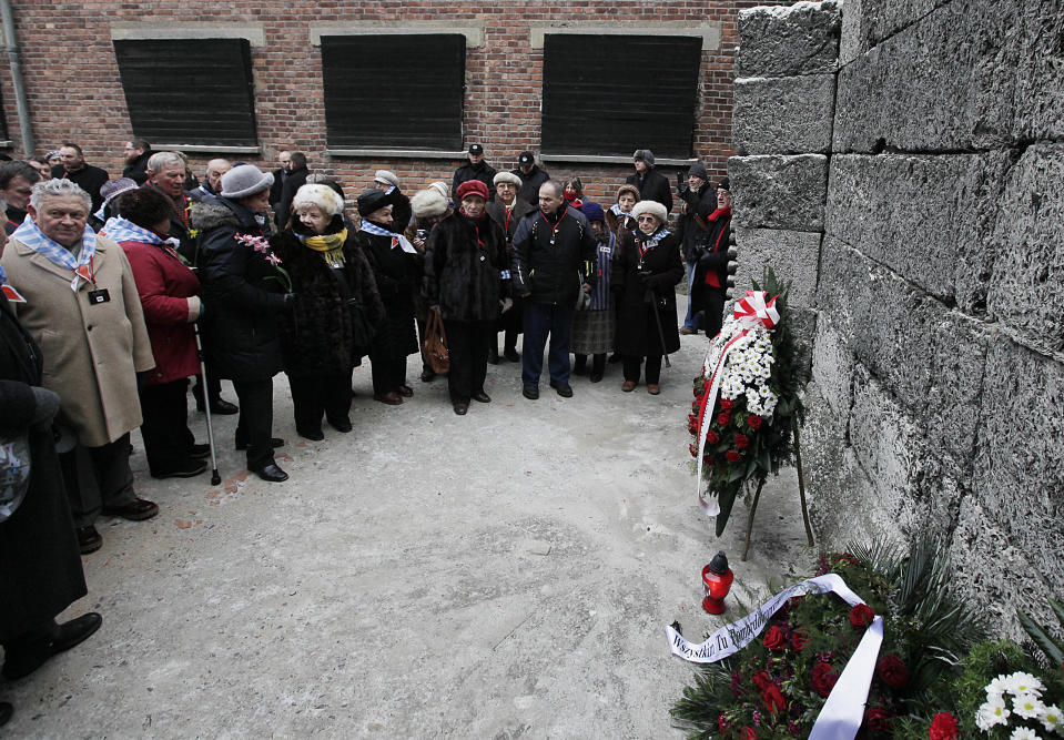 Auschwitz survivors lay a wreath at the former Nazi death camp's Wall of Death in Oswiecim, Poland, on Monday, Jan. 27, 2014, to mark 69 years since the Soviet Red Army liberated the camp. Israeli lawmakers and government officials are to attend anniversary observances later in the day. The Nazis killed some 1.5 million people, mostly Jews at the camp during World War II. (AP Photo/Czarek Sokolowski)