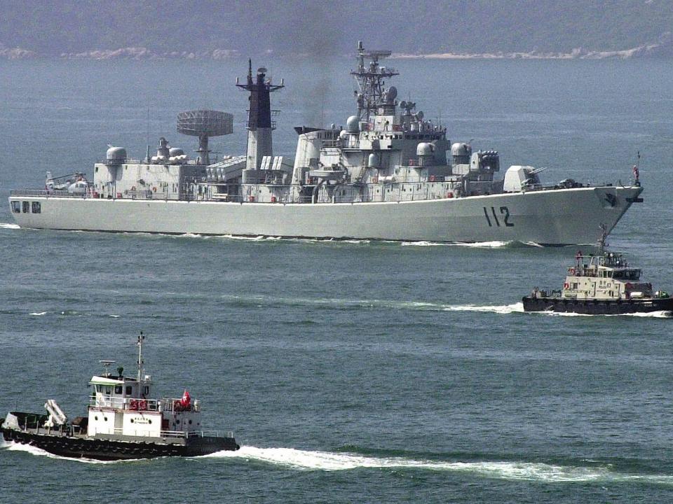 China's guided missile destroyer Harbin is escorted into Hong Kong, early 30 April 2004, part of a Task Force visiting the territory.