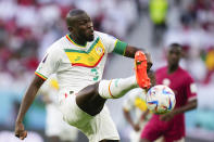 Senegal's Kalidou Koulibaly fires a shot during a World Cup group A soccer match against Qatar at the Al Thumama Stadium in Doha, Qatar, Friday, Nov. 25, 2022. (AP Photo/Petr Josek)