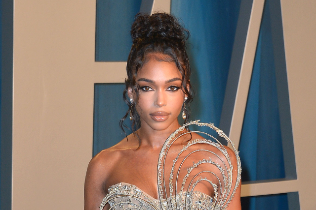 Lori Harvey Stylishly Sips Wine in Chanel Thong Sandals & Pleated