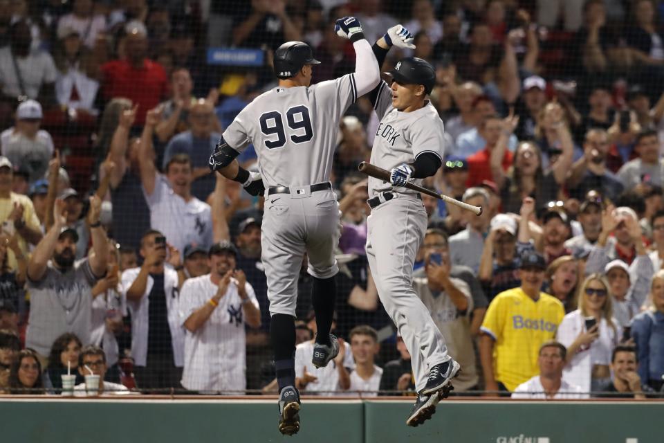 New York Yankees' Aaron Judge (99) celebrates his solo home run against the Boston Red Sox with Anthony Rizzo during the third inning of a baseball game Friday, Aug. 12, 2022, in Boston. (AP Photo/Michael Dwyer)