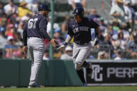 New York Yankees Anthony Volpe is greeted by third base coach Luis Rojas (67) on his solo homer in the fifth inning of a spring training baseball game against the Boston Red Sox in Fort Myers, Fla., Sunday, March 12, 2023. (AP Photo/Gerald Herbert)