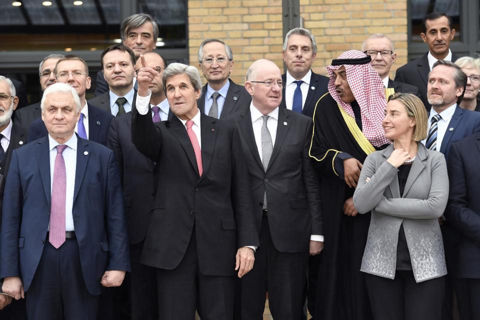 US Secretary of State John Kerry, 2nd left, gestures while posing with Russian Ambassador to France Alexander Orlov, left, and European Union Foreign Policy Chief Federica Mogherini, right, as they take part with other foreign ministers and representatives in a family picture during a Mideast peace conference in Paris, Sunday, Jan. 15, 2017. Fearing a new eruption of violence in the Middle East, more than 70 world diplomats gathered in Paris on Sunday to push for renewed peace talks that would lead to a Palestinian state. (Bertrand Guay/Pool Photo via AP)