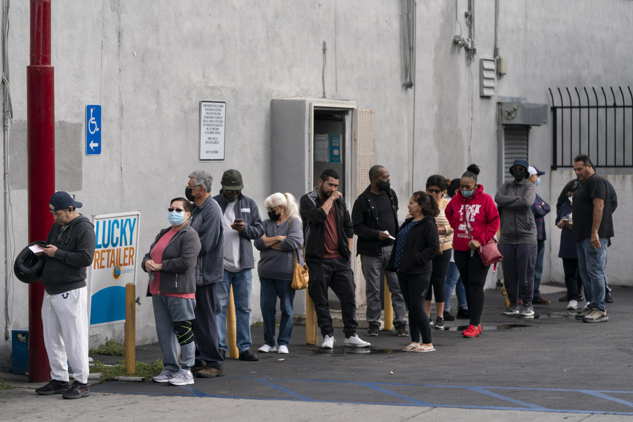 People wait in line outside Bluebird Liquor to buy Powerball lottery tickets in Hawthorne, Calif., Wednesday, Nov. 2, 2022. The estimated jackpot for Wednesday night's drawing climbed over a billion. (AP Photo/Jae C. Hong)