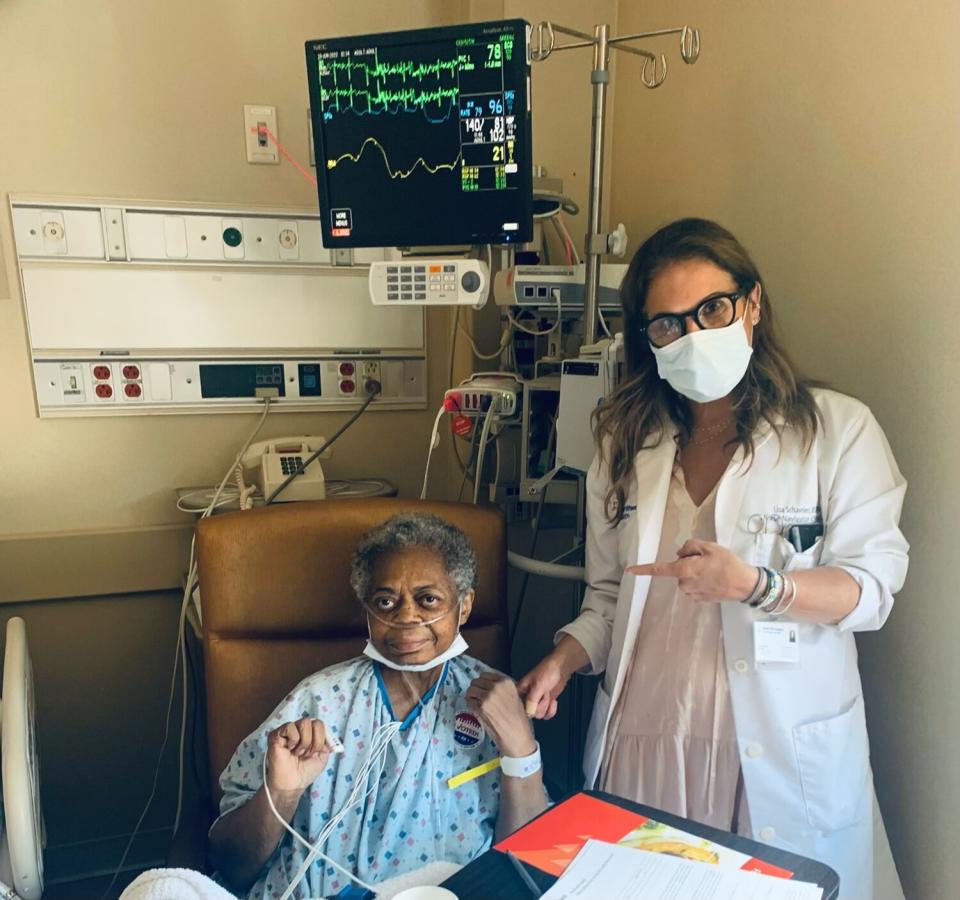 NYC nurses Lisa Schavrien and Erin Ainslie Smith help patients cast ballots from their bedside