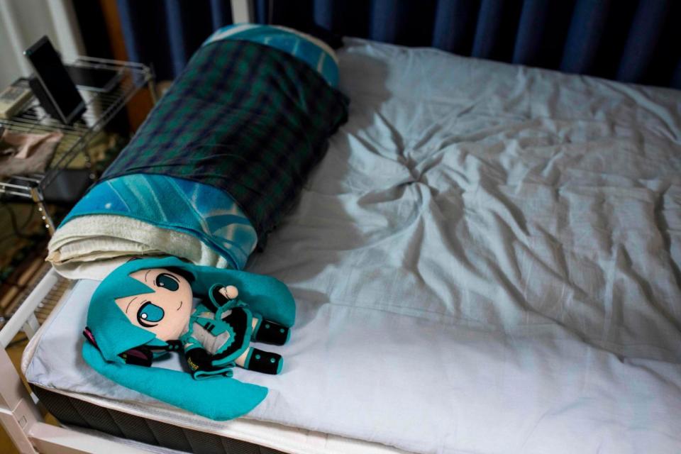 Mr Kondo sleeps next to a Miku doll every night, and is woken up in the morning by her voice, set as an alarm. (AFP/Getty Images)