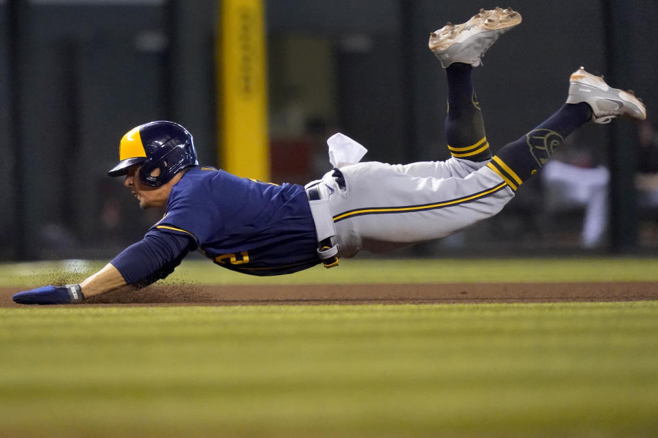 Milwaukee Brewers' Luis Urias advances to third on a base hit by Tyrone Taylor during the seventh inning of a baseball game against the Arizona Diamondbacks, Wednesday, June 23, 2021, in Phoenix. (AP Photo/Matt York)