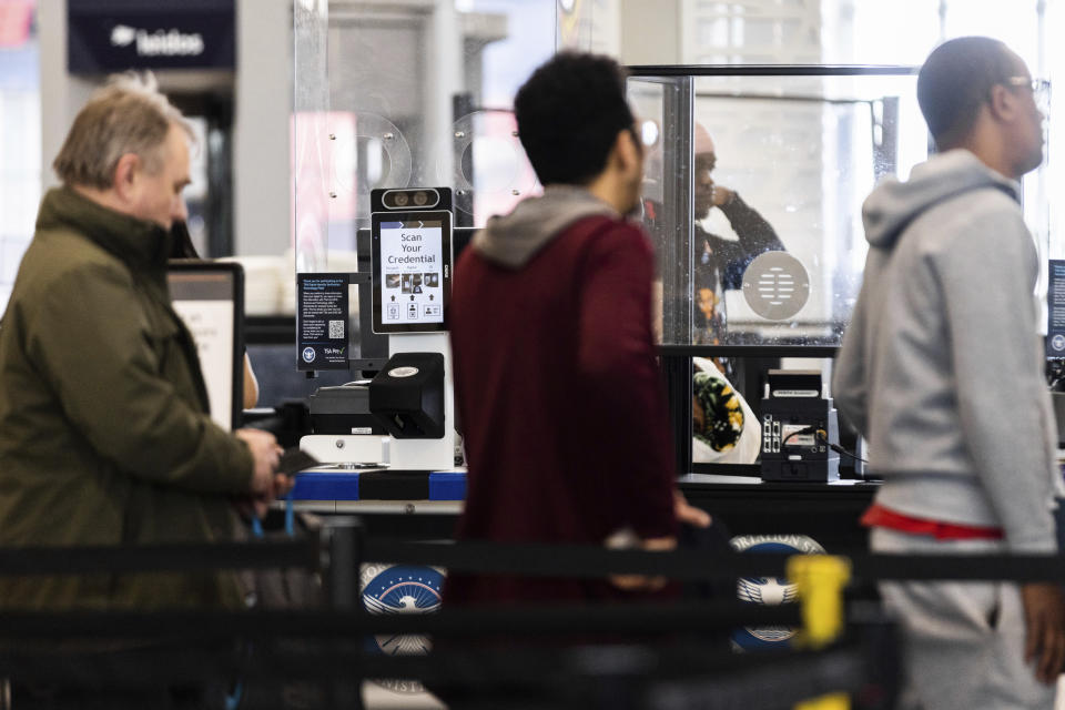 Travelers wait in line at a Baltimore-Washington International Thurgood Marshall Airport security checkpoint to use the Transportation Security Administration's new facial recognition, Wednesday, April 26, 2023, in Glen Burnie, Md. (AP Photo/Julia Nikhinson)