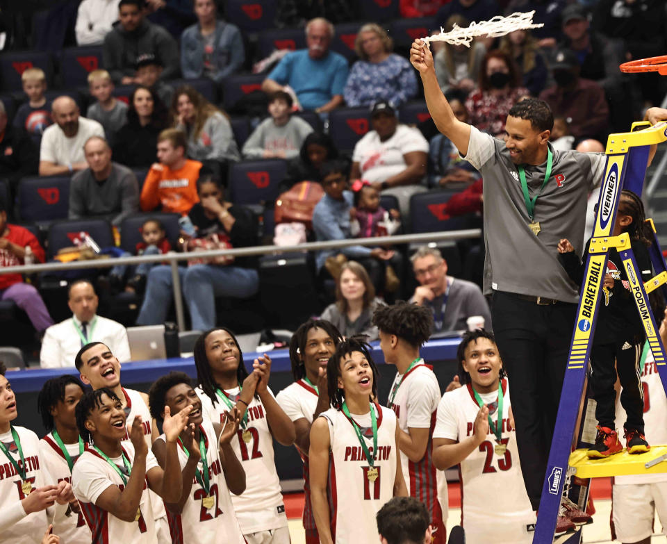 Princeton coach Bryan Wyant cuts down the nets after the Vikings' win over Moeller in the Division I district final Saturday, March 4, 2023.