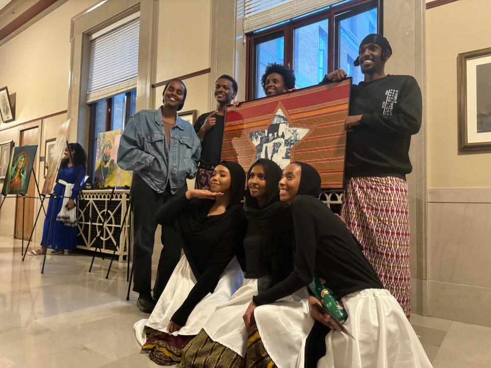 Ilham Hassan, a Somali American who drew a replica of the Somali flag that was on display, poses next to dance group, Cabsi Cabsi, after the Africa Day event concludes.
(Credit: Amani Bayo)