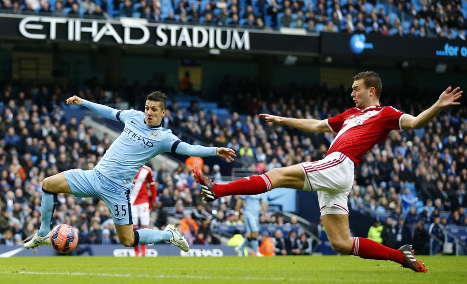 Middlesbrough's Ben Gibson challenges Manchester City's Stevan Jovetic (L) during their English FA Cup 4th round soccer match at the Etihad Stadium in Manchester, northern England, January 24, 2015. REUTERS/Darren Staples (BRITAIN - Tags: SPORT SOCCER)