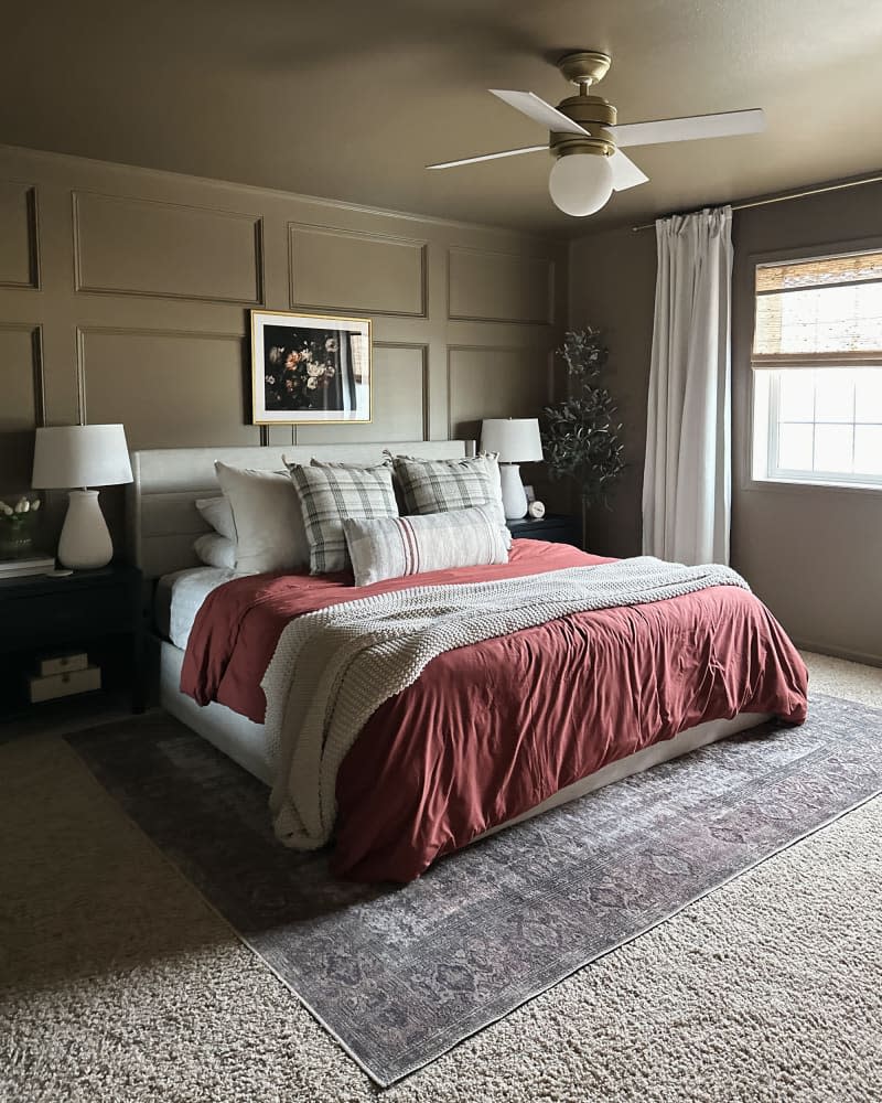 Green painted moulding behind bed in newly remodeled bedroom.