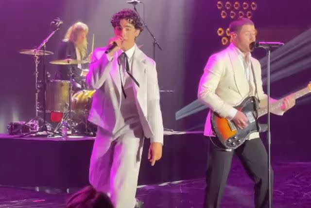 <p>Andrea Mandell</p> Joe and Nick Jonas on stage at AMfar Cannes.