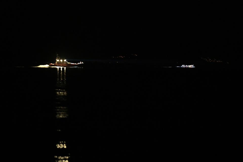 A patrol boat uses a light to spot a dinghy with refugees and migrants between Turkey and Skala Sykaminias village, on the northeastern Aegean island of Lesbos, Greece, Tuesday, Sept. 24, 2019. More than 2,300 migrants reached Lesbos last week, the highest rate of arrival this year. (AP Photo/Michael Varaklas)