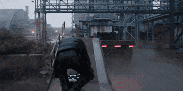 A man lands a motorcycle on a flatbed truck