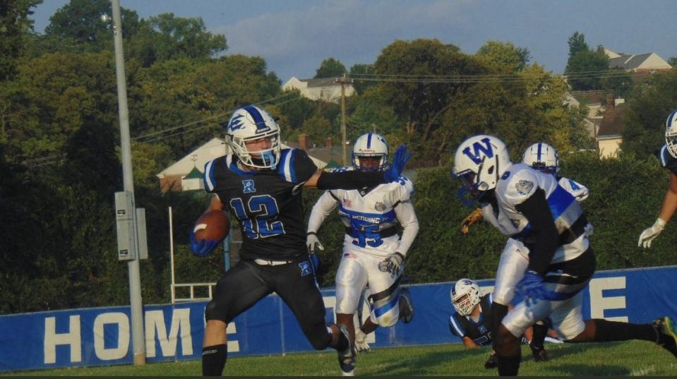 Reading running back Austin Fancher (12), pictured here against Woodward in Week 1, ran for eight touchdowns in the Blue Devils' victory over Summit Country Day on Friday, Sept. 1, 2023.