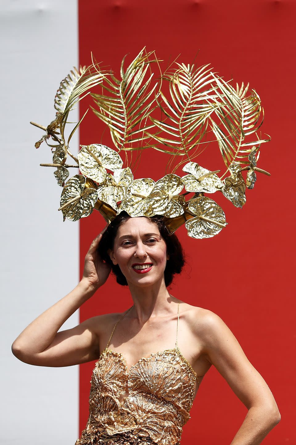 <p>Going for the gold, this attendee wore a Greek goddess-inspired gold leaf headpiece. </p>