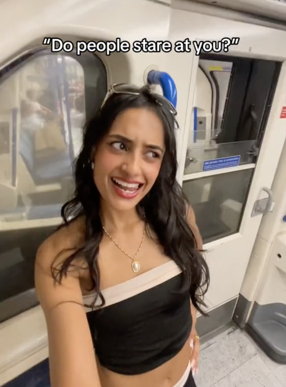 Screenshot of Sabrina Bahsoon, 'Tube Girl', on the London underground with the caption 