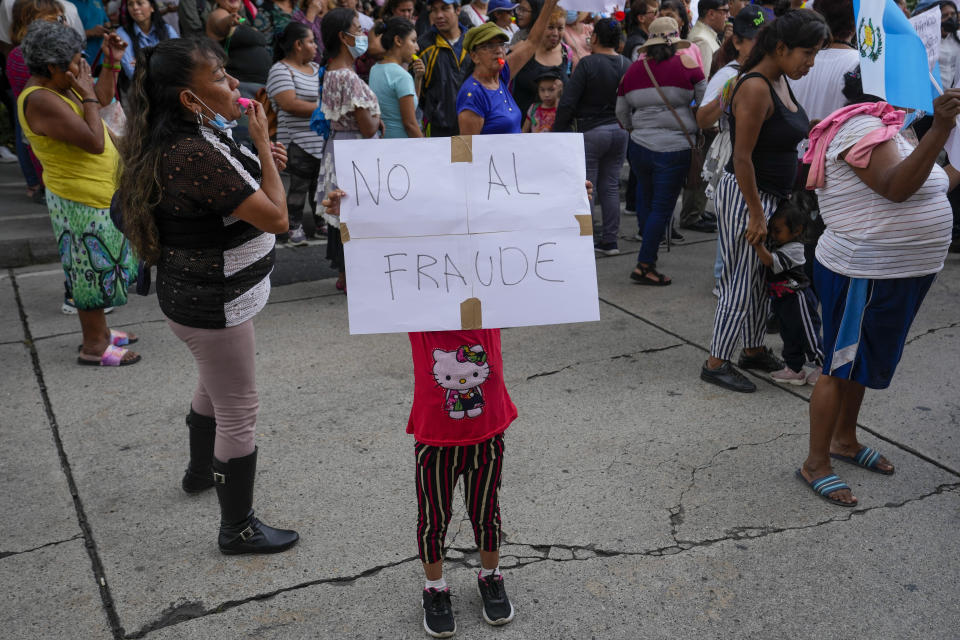 Una niña muestra un cartel con un mensaje contra el fraude electoral en una protesta que defiende que hubo fraude en el balotaje de la elección presidencial, al frente del edificio del Tribunal Supremo Electoral, en Ciudad de Guatemala, el miércoles 30 de agosto de 2023. El partido de la ex primera dama Sandra Torres, que perdió ante Bernardo Arévalo, presentó una denuncia el 25 de agosto alegando que hubo fraude en el conteo de votos. (AP Foto/Moisés Castillo)